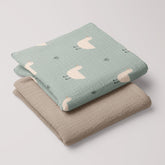 Folded Minty Duck muslin swaddle paired with latte 4-ply muslin blanket